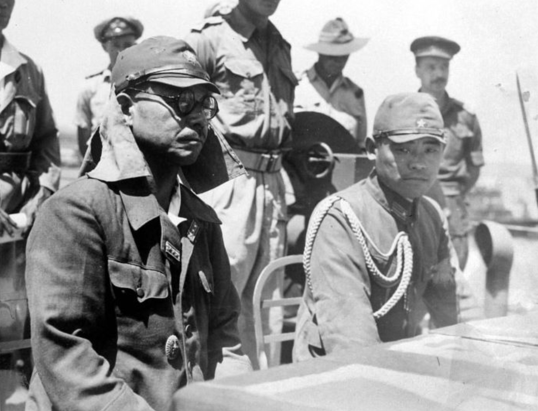 Japanese commanders listen to the terms of surrender aboard an Australian warship. 